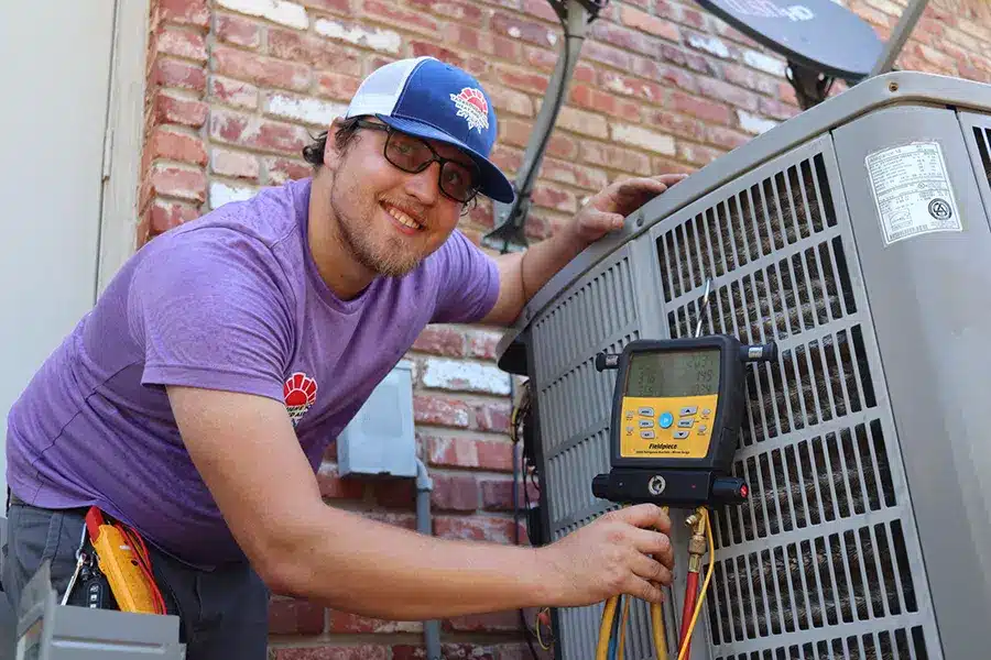 HVAC technician performing AC tune-up test in Oklahoma City